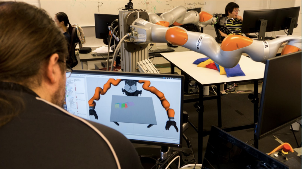 A U-M graduate student operates a KUKA robot similar to the ones used in Carol Menassa’s robot apprentice research. The $2M project aims to enable robots to learn from and cooperate with human construction workers.
