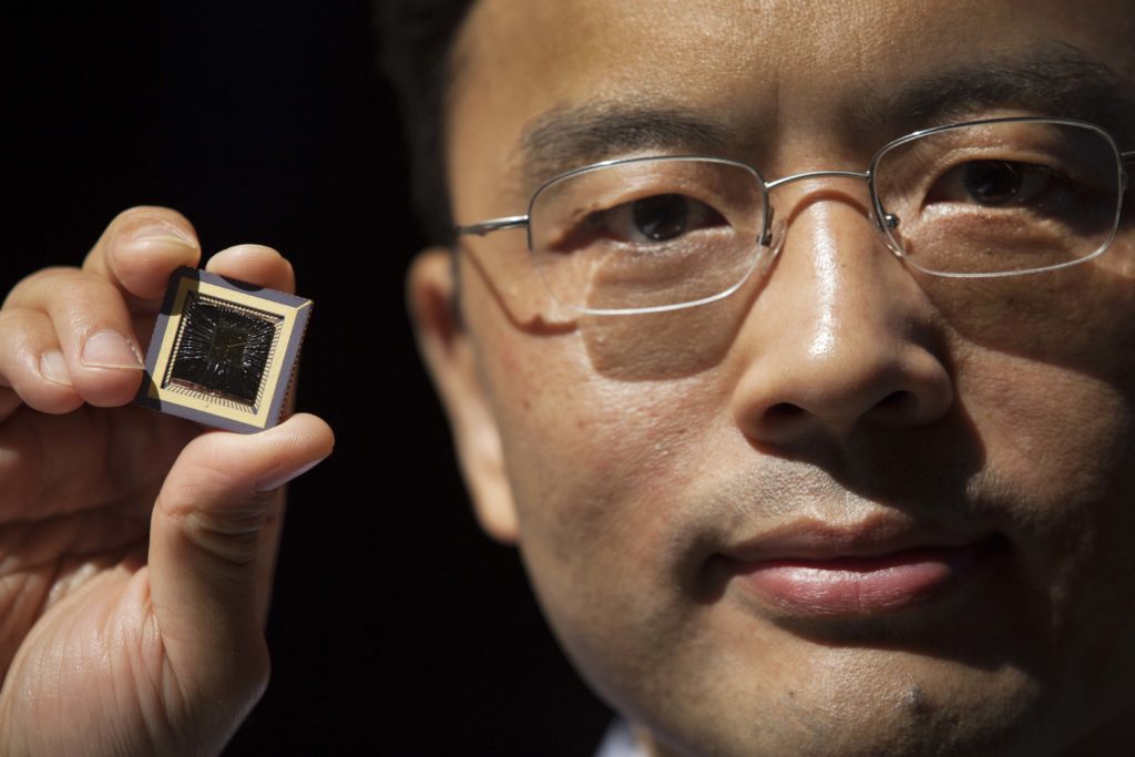Wei Lu, Professor of Electrical Engineering & Computer Science at the University of Michigan holds a memristor he created. Photo: Marcin Szczepanski.