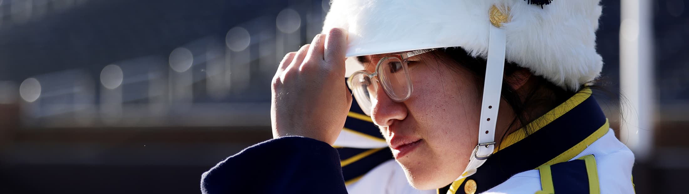 Rachel Zhang stands in the Big House, adjusting her uniform
