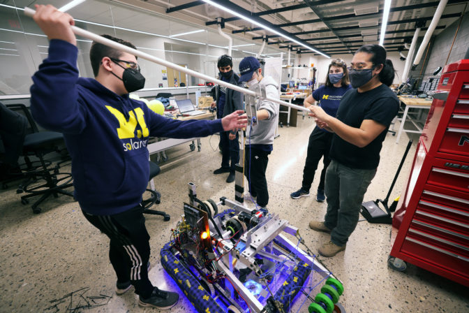 Members of the FAMN team test their robot’s climbing mechanism.