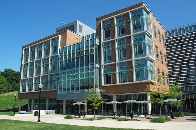 Front of a brick and glass building.