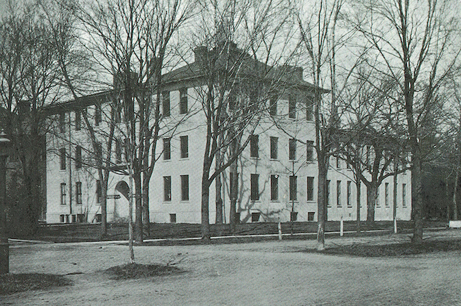 Black and white photo of a large square building.