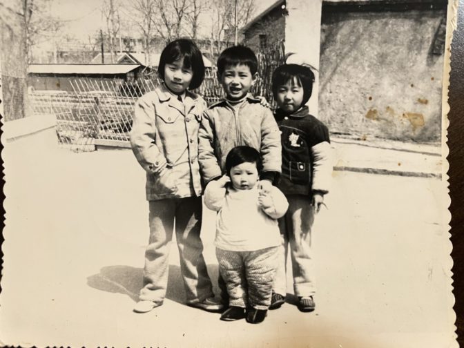 Zhang, at left, poses with cousins in China before her move to the United States in 1985.