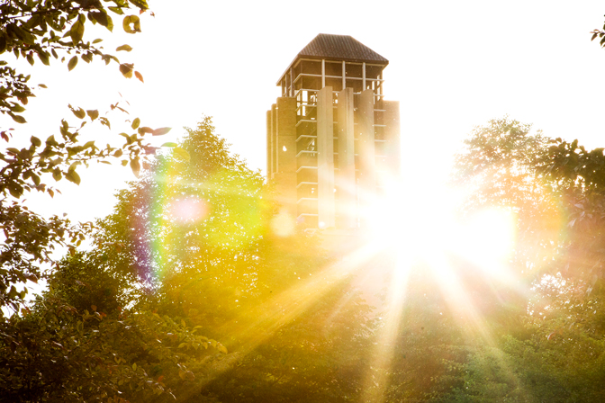 The sun shining on the Lurie Bell Tower in North Campus