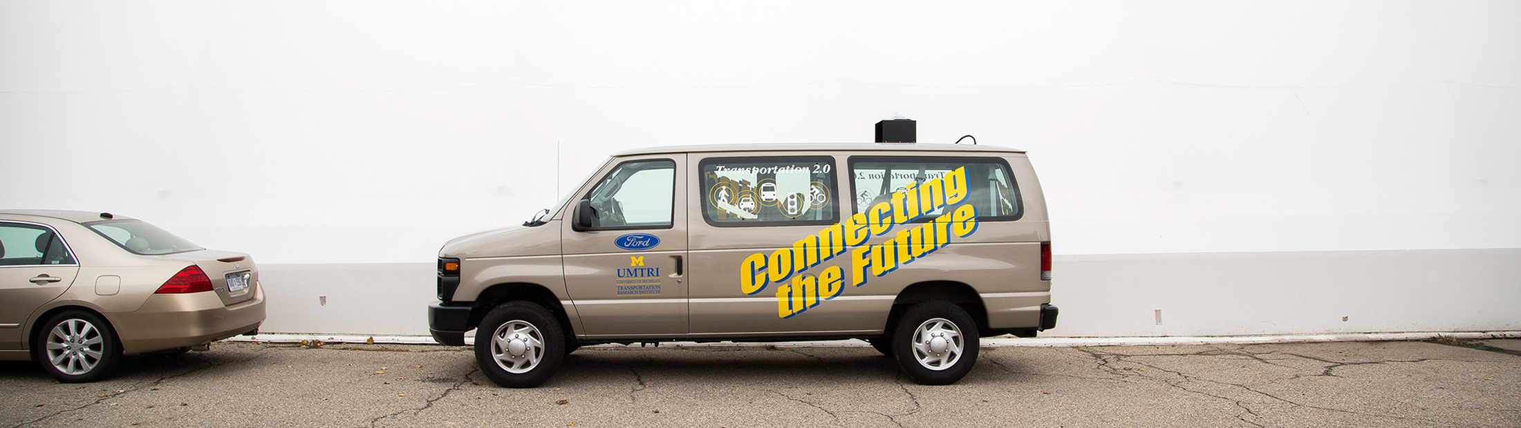 A parked van with a decal reading "Connecting the Future"