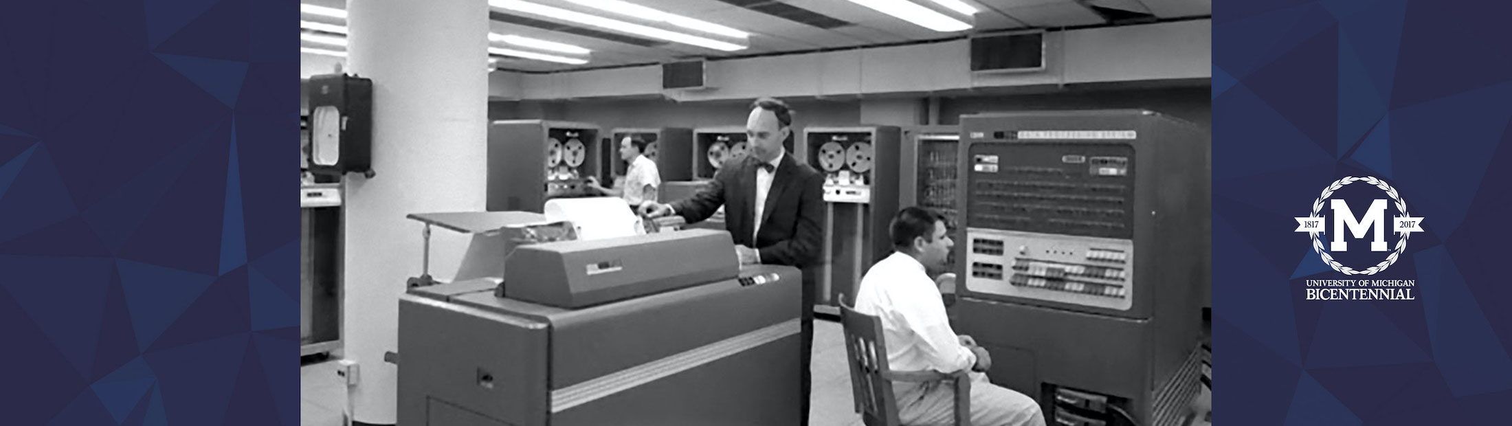 Two people with the IBM704 computer printer at the Computing Center