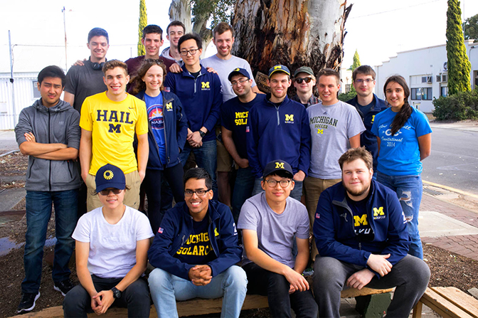A group picture of students in Michigan apparel.