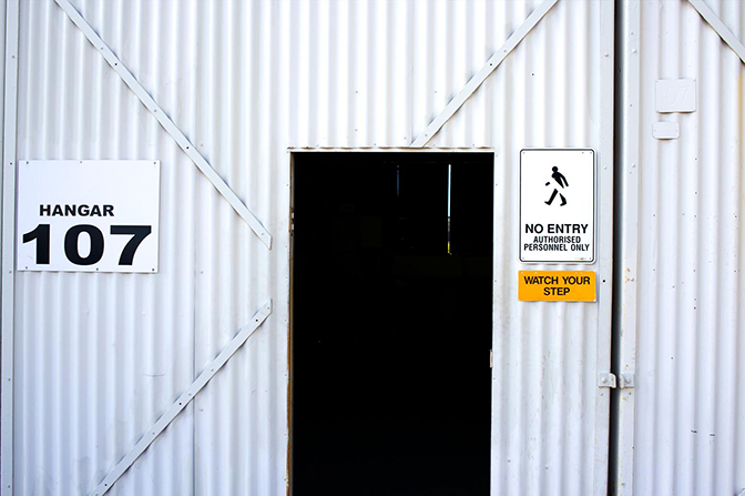 A door of a building labeled "Hangar 107".