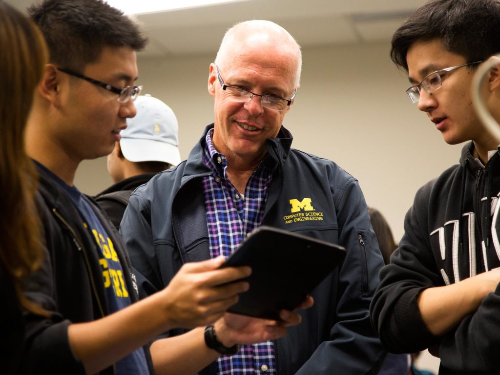 Professor talks with two students