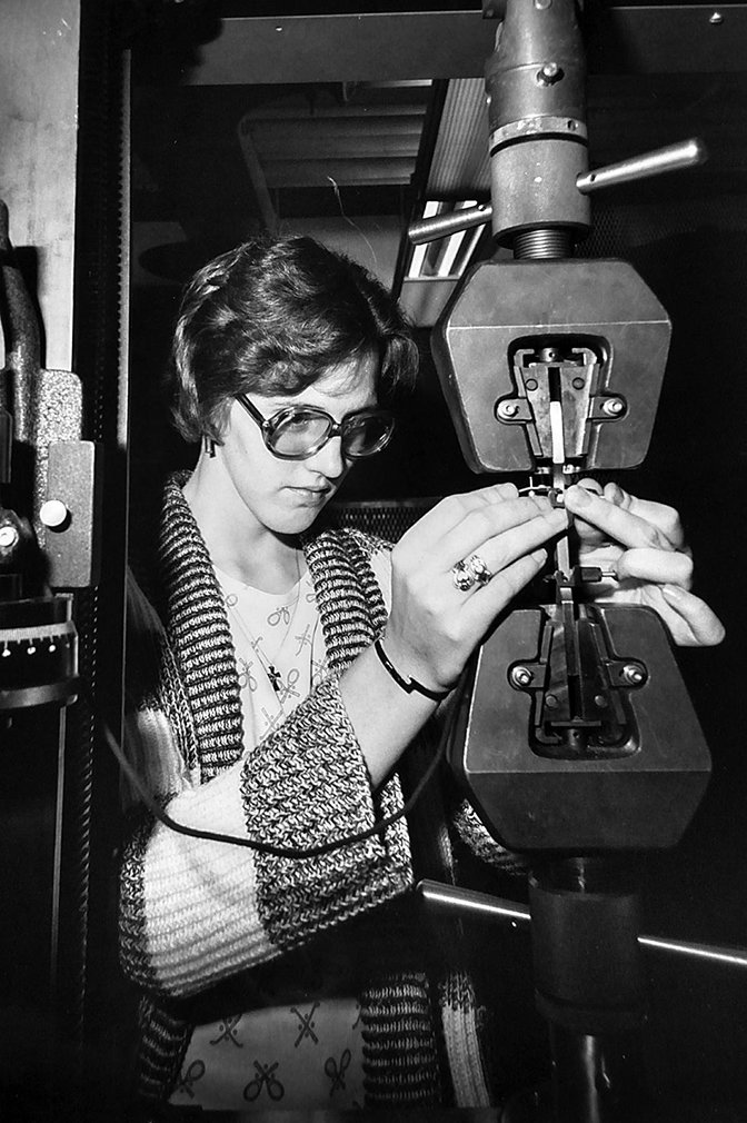 A student adjusts a device.