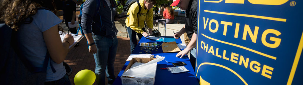 People at a table labeled "Big 10 Voting Challenge."
