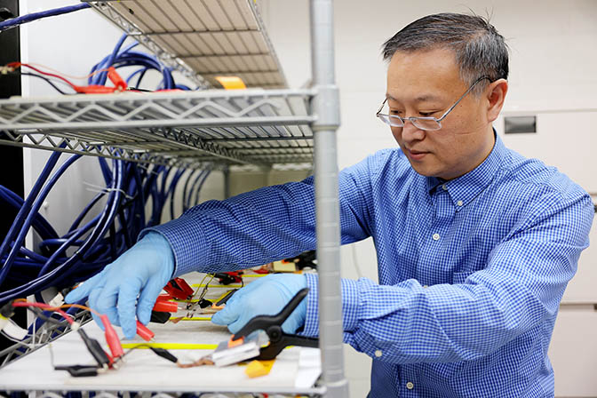 Wei Lu, a U-M professor of mechanical engineering cycling batteries in the Lu Lab at the George G. Brown Laboratories building on the North Campus of the University of Michigan in Ann Arbor on Tuesday, May 31, 2022.
