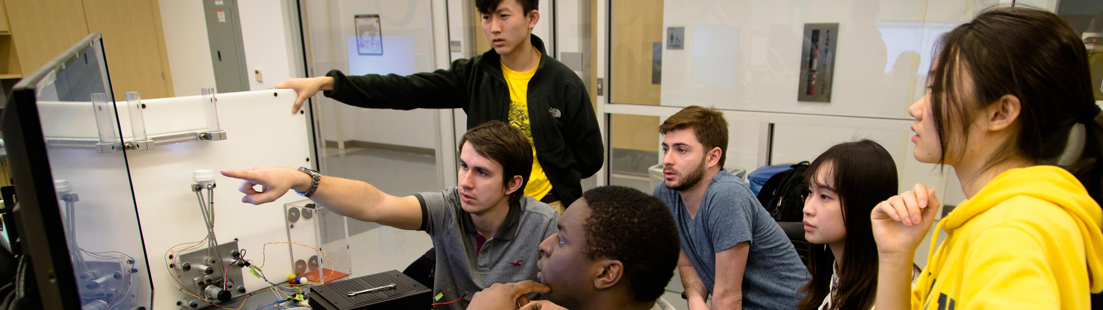 Students looking at a computer