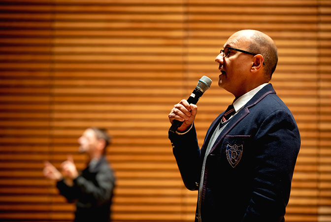 Shidan Majidi speaking into a microphone.