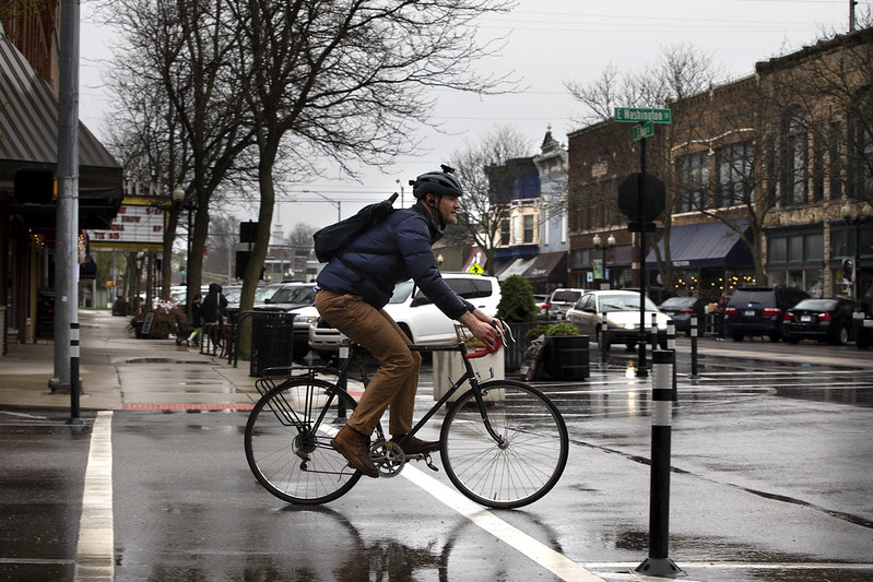A man riding a bike in Goshen's downtown area