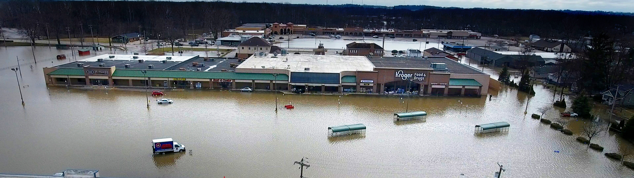 an aerial photograph of a flooded grocery plaza
