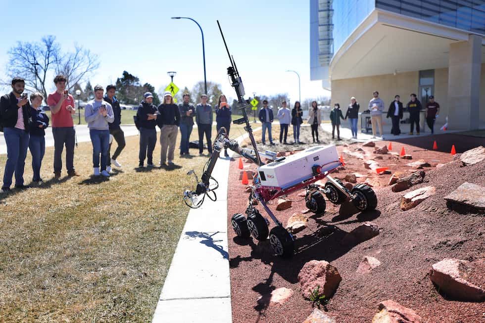 During a mock mission, the Mars Rover executes commands from MRover team members inside the Ford Motor Company Robotics Building, simulating Earth-based teams sending commands to a space rover.