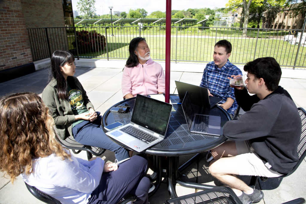 CHEPS students sit on the patio working