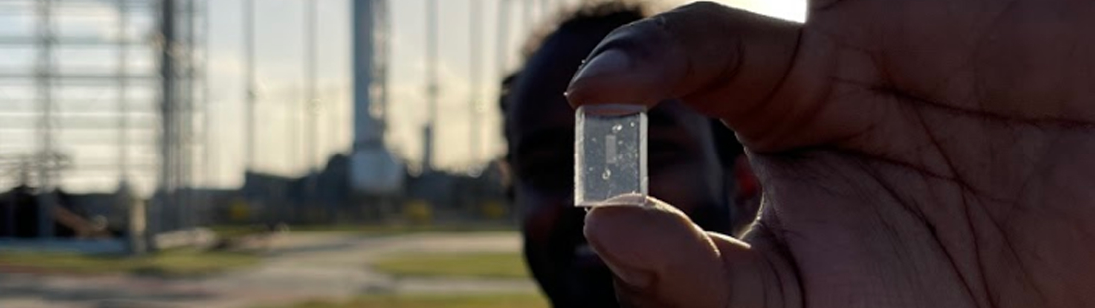 A man holds the chip that will be sent to the international space station