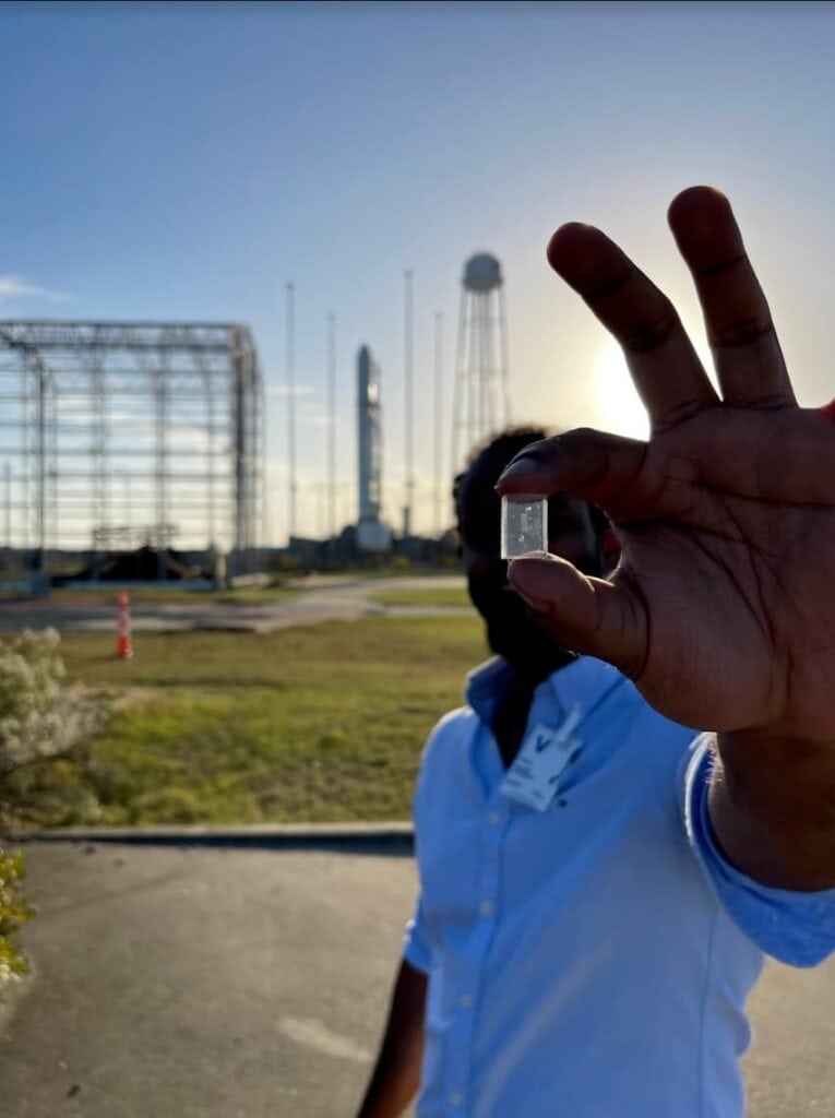 A man holds the chip that will be sent to the international space station