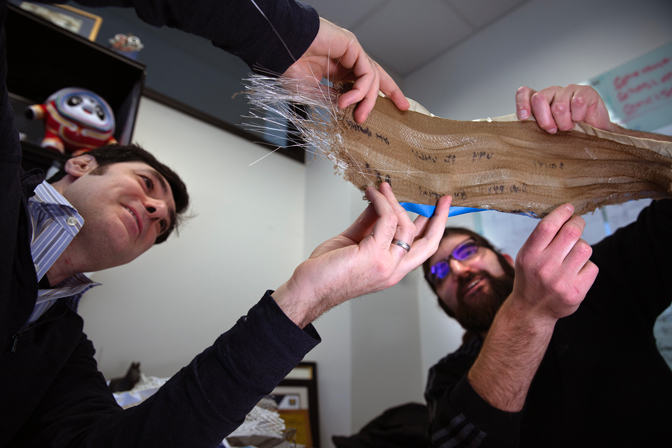 Max Stein and Brian Iezzi analyze the fabric with photonic fibers woven into it. 