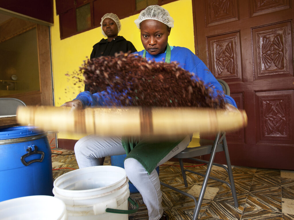 Jocelyne Diomètre removes the shells from crushed cacao using a Haitian basket called a laye. 