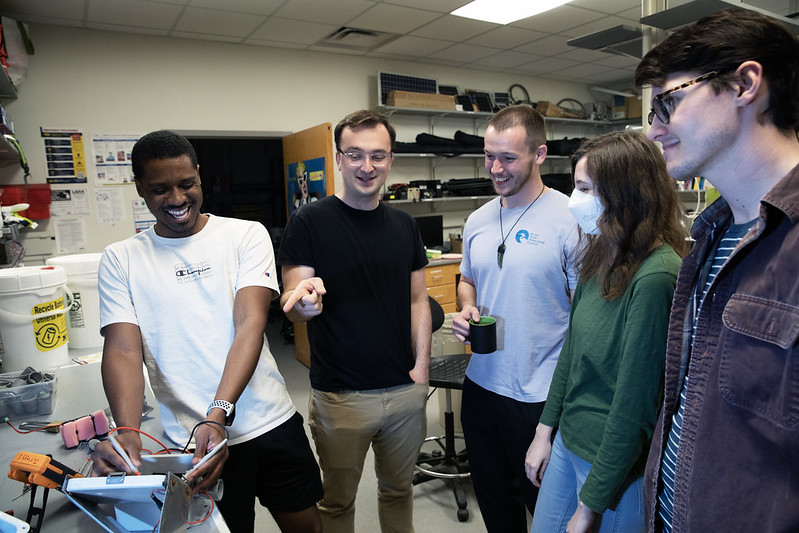 Kerkez (second from left) shares a laugh as he discusses with his students water sensors they install in watersheds in southeast Michigan and beyond. From left are Ken Ferrell, Branko Kerkez, Travis Dantzer, Meagan Tobias and Bryon Banman. Photo: Marcin Szczepanski/Michigan Engineering.