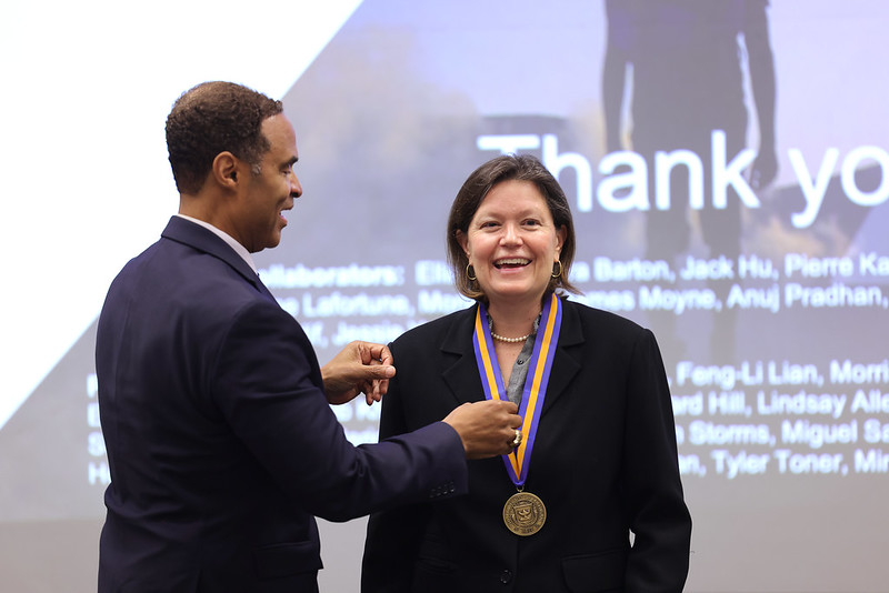 Alec Gallimore presents Dawn Tilbur with a medal in 2022.