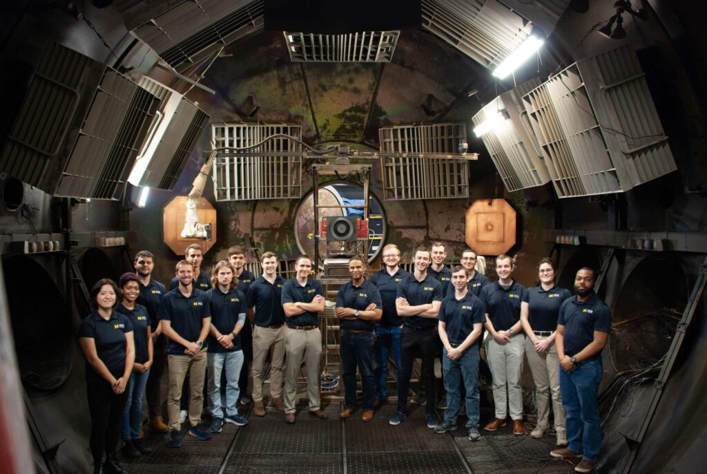 Alec Gallimore, Ben Jorns and PEPL researchers stand in the vacuum chamber