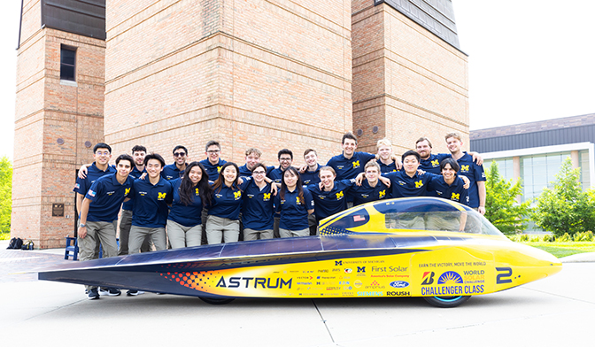 The entire Michigan Solar Car race crew poses behind Astrum