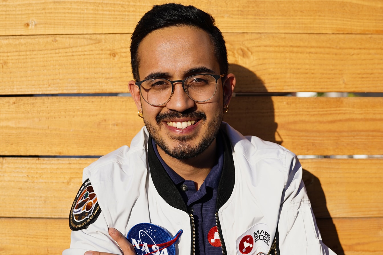 Elio Morillo smiles while wearing a NASA jacket