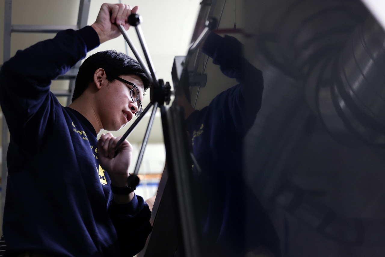 Sirawit Shimpalee, an undergraduate majoring in naval architecture and marine engineering, works with PhD candidate Taeksang Kim in the Hydraulic and Coastal Engineering Laboratory in the GG Brown Building on North Campus