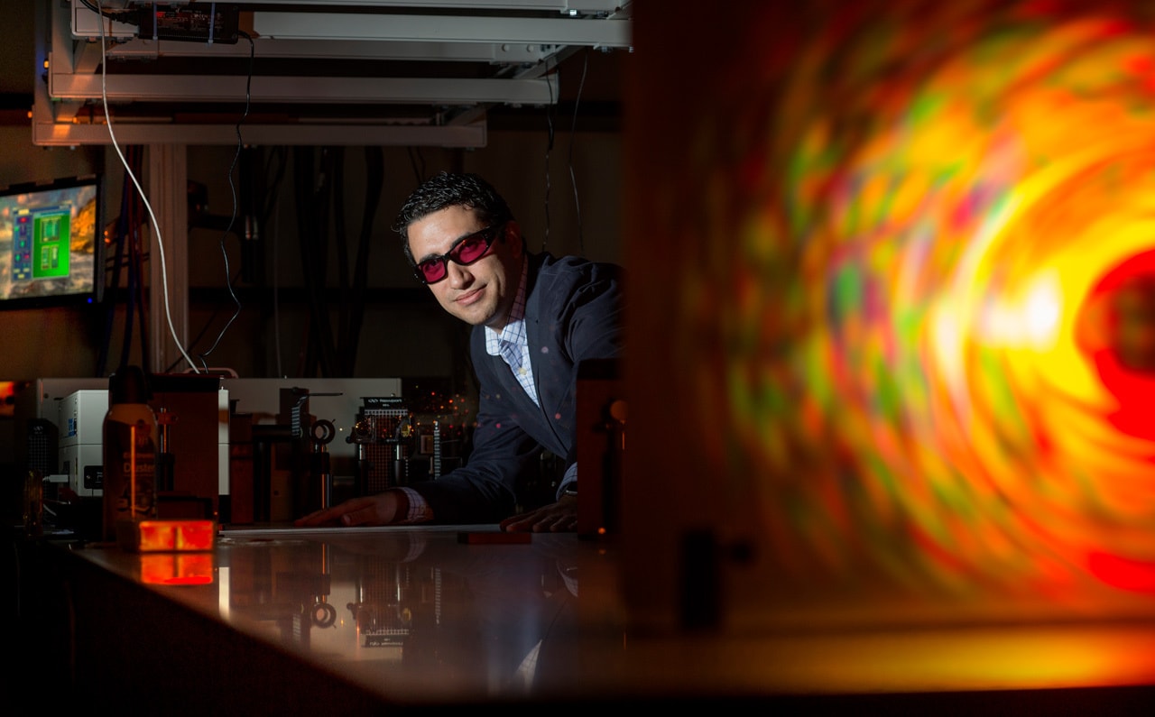 Franklin Dollar, stands behind a laser for laser plasma research, in the ZEUS laser lab.