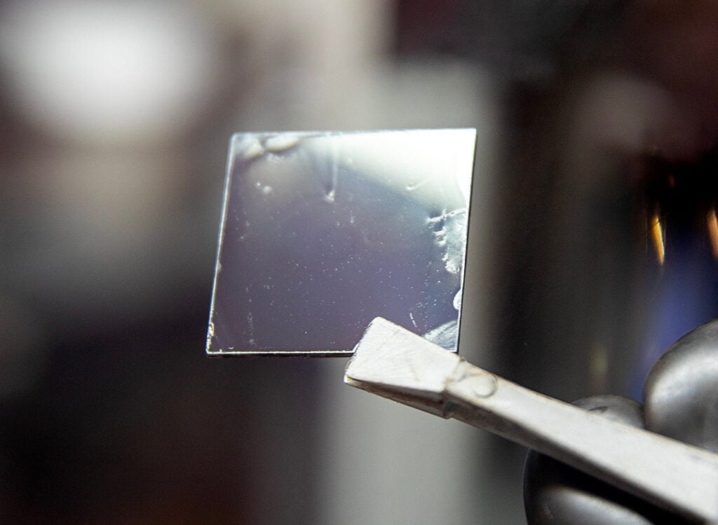 A close up shot of the perovskite material being held up by a researcher 