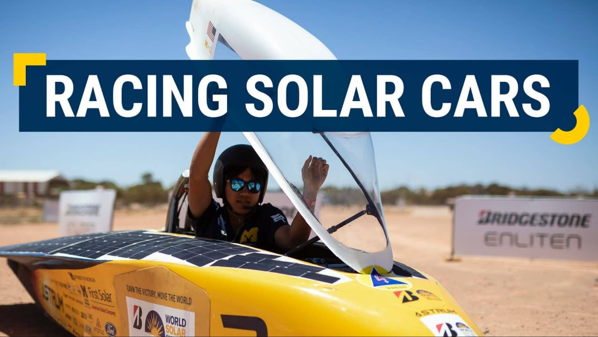 A student sits in the driver's seat of the small solar car