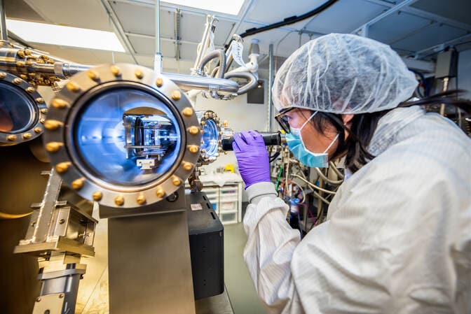 Pan shines a light into one of the portholes of the machine. In the foreground, we look down one of the silvery tubes with blue-white light reflecting on the inner wall.