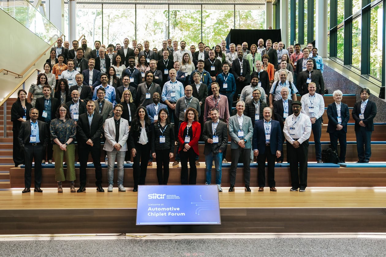 Chiplet Forum attendees stand for a group photo in a large room