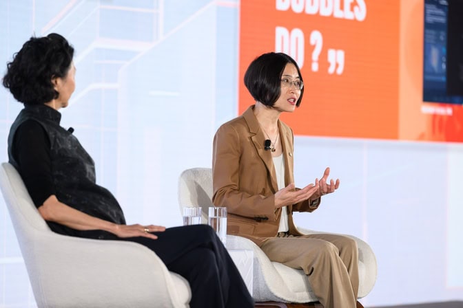 Zhen Xu and Solina Chau right on stage at a professional conference.