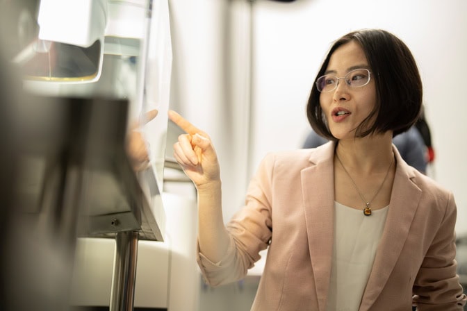 Zhen Xu points at a screen while demonstrating the histotripsy technology.