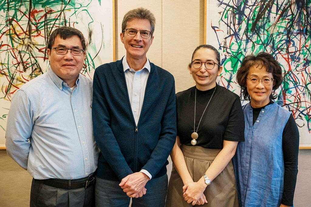 4 people standing for a portrait.