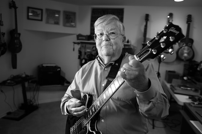 Daniel Atkins holding a guitar