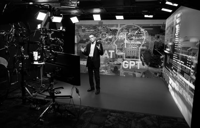 Wallace Hopp talking to a monitor. 