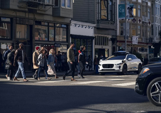 Pedestrians crossing the street in front of autonomous vehicle