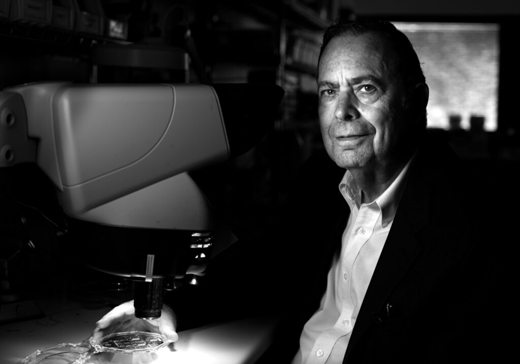 Kensall Wise examines electronics under a microscope