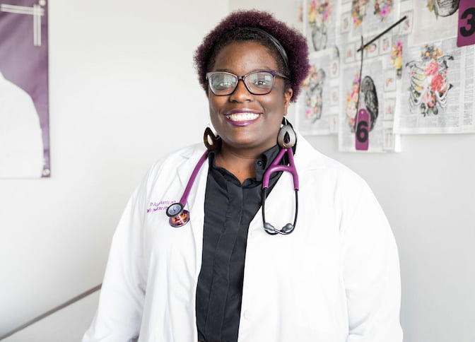Portrait of Aisha Harris smiling.