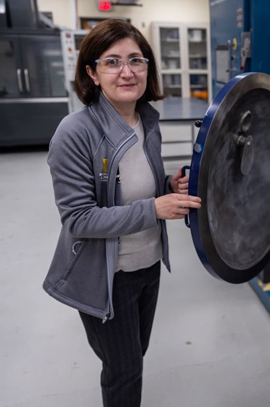 Portrait of Sahar Farjami wearing safety goggles in the lab.