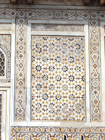 Decorative wall panel with geometric and floral patterns.