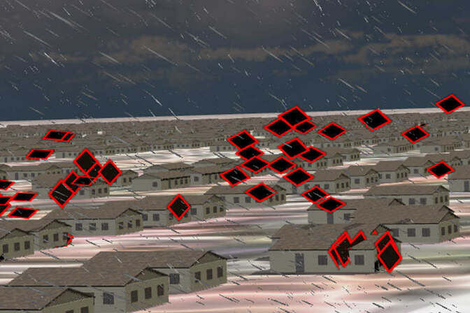Tiles outlined in red blow off the roofs of buildings in a simulated city.