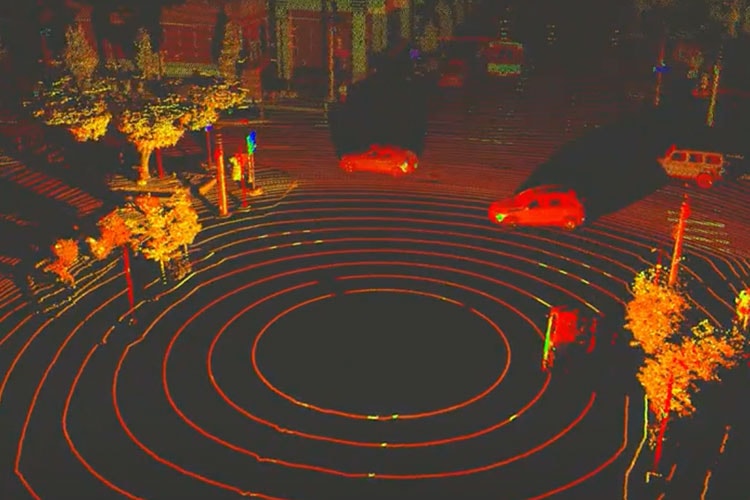 On a black background, cars are represented as red and yellow vehicle shapes. Concentric circles in the foreground represent the lidar's path.