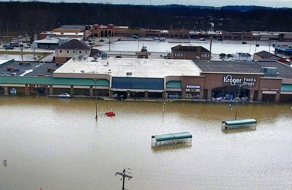 an aerial photograph of a flooded grocery plaza